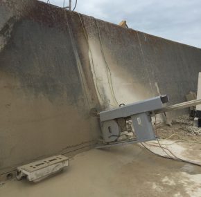 Wire saw fixed to sea defence wall, ready for cutting